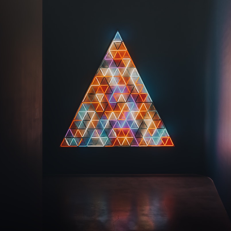 Colorful triangle made of lights with smaller triangles inside it